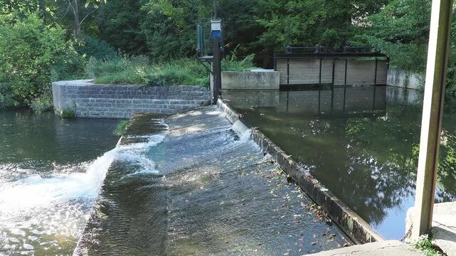 River Water Flowing over a Concrete Weir at a Small Water Control Structure