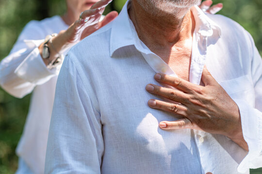 Man placing a hand over his heart while receiving a guided chakra healing practice, representing emotional connection, self-awareness, spiritual balance, and mindful presence.
