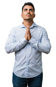 Man young casual clothes begging, praying, beg and pray with hands together, emotional expression, seeking hope - studio portrait of a handsome adult pleading for help and forgiveness