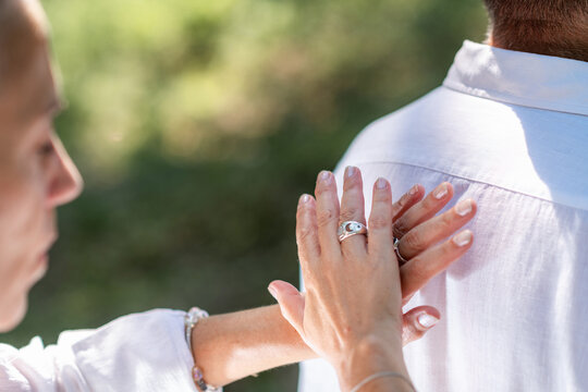 Hand on the upper back while using the other for energy work during a chakra balancing session focused on relaxation, spiritual connection, and emotional wellbeing.