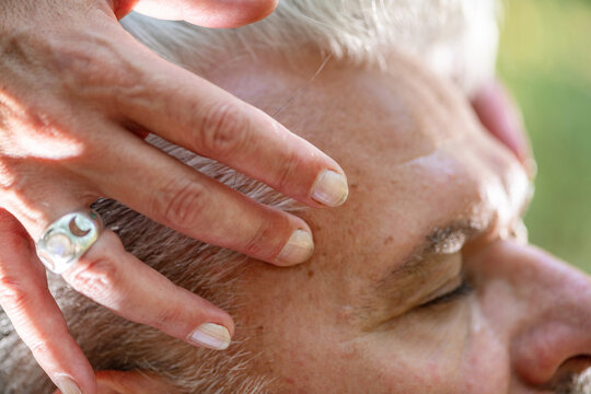 Close-up of gentle hand placement near the forehead during a guided spiritual healing practice focused on third eye chakra awareness, mindfulness, relaxation, and energy balance.