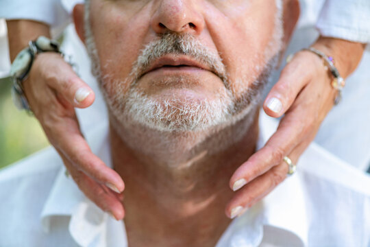 Hands positioned around the throat and neck during a guided chakra healing session, symbolizing energetic balance, spiritual awareness, mindful connection, and holistic wellness.