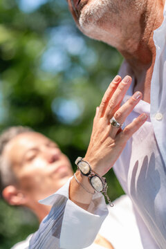 Practitioner using gentle hand placement near the heart and chest during a chakra balancing practice focused on spiritual healing, emotional harmony, and mindful awareness.
