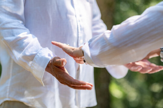 Open hand energy balancing technique around the lower torso during a guided spiritual healing practice focused on mindfulness and holistic wellbeing.