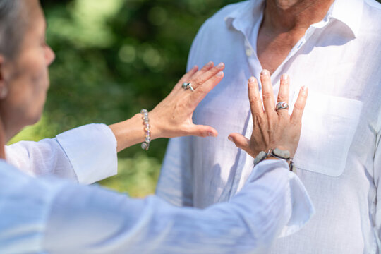 Positioning both hands near the chest during a heart chakra balancing session focused on spiritual connection, emotional harmony, mindfulness, and energy healing.