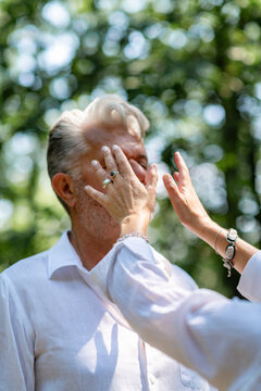 Hands around the face and head during a chakra balancing session, symbolizing focused energy work, spiritual awareness, mindfulness, and emotional harmony.