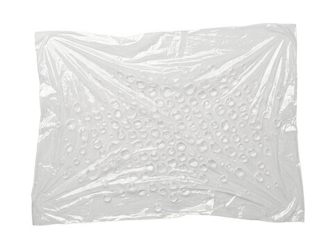 Crinkled transparent plastic wrap with bubble texture laid flat on a transparent surface.