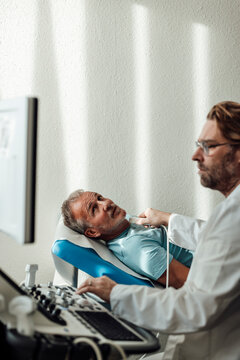 Doctor performing AI assisted ultrasound examination on patient