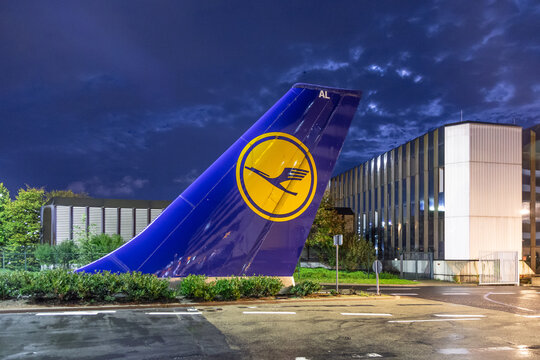tailsign and tailrudder in front of main entrance of Lufthansa Gate 21 in Frankfurt, Germany by night