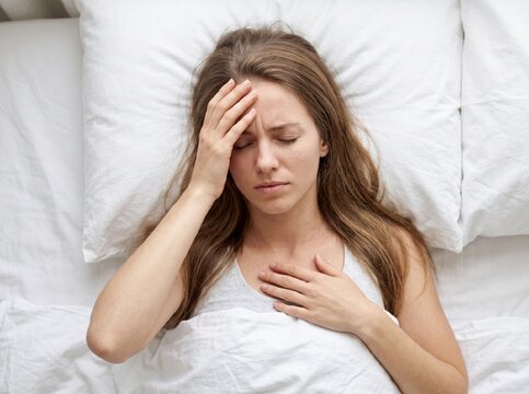 Stressed female suffering from chronic migraine and tension ache