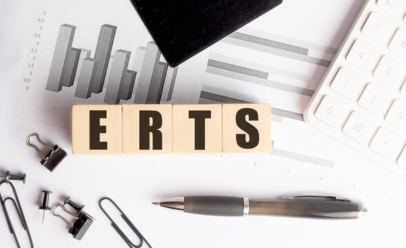  Erts acronym on wooden letter blocks with financial charts, calculator and stationery on an office desk