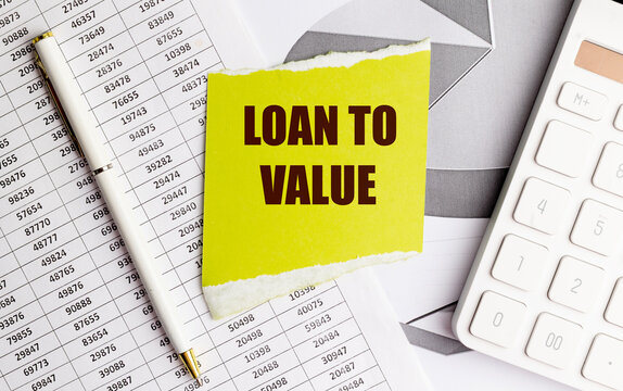 Loan to value text on yellow paper with financial charts, , concept of mortgage ratio and lending risk assessment
