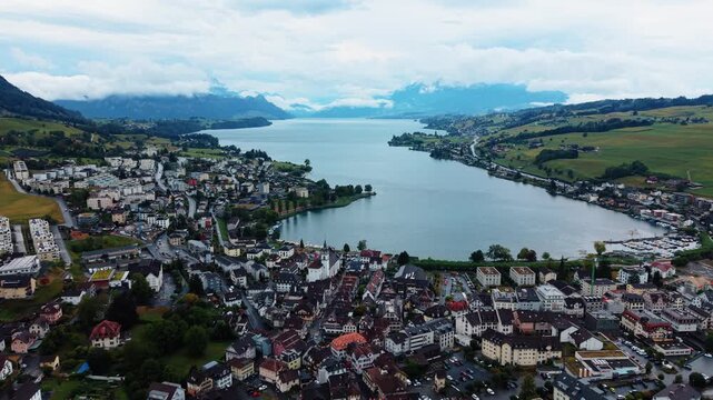 Kussnacht and Lake Lucerne broaden into view as the drone pulls backward.