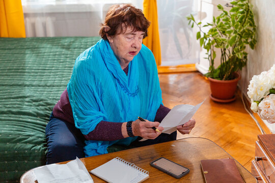 Older Caucasian woman checking budget. Realistic lifestyle and concern. Concept of poverty. Mid shot