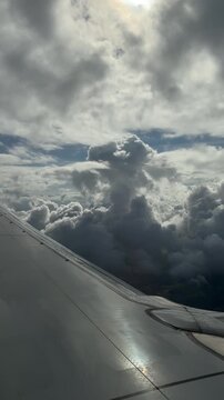 Sleek metal winglets cruise smoothly above dreamy white clouds.