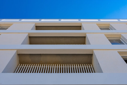 Detail of apartment building balcony slabs and wooden soffit from below