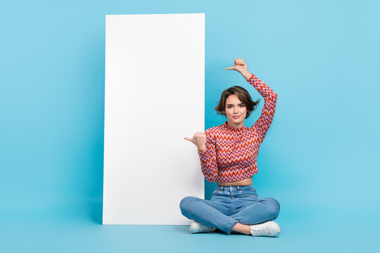Full length photo of adorable positive woman dressed print top showing two thumbs device empty space isolated blue color background