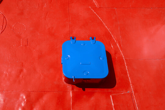 blue metal raised ship deck hatch, high angle view