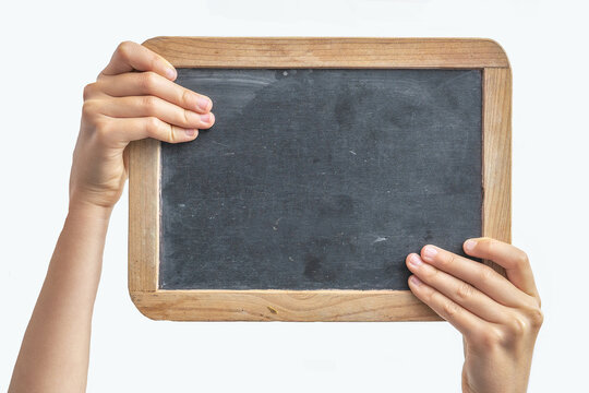 child children's hands holding empty school blackboard chalkboard with wooden frame, isolated on white background