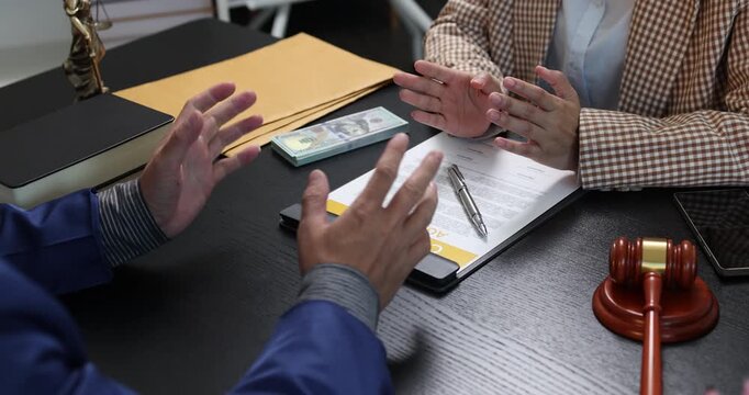 Legal consultation between a lawyer and a client, reviewing contract terms and discussing legal options to resolve disputes, protect rights, and make informed decisions.