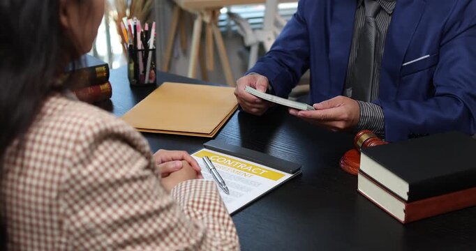Legal consultation between a lawyer and a client, reviewing contract terms and discussing legal options to resolve disputes, protect rights, and make informed decisions.