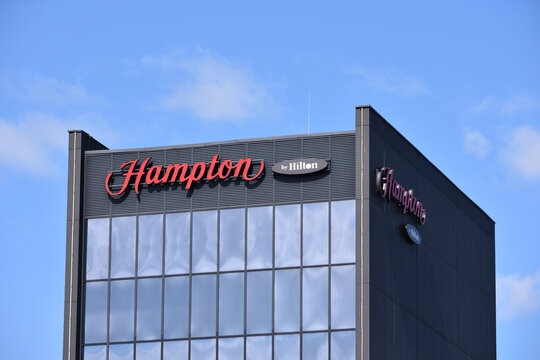 Hampton Hilton hotel facade with emblem, signage, logo. WARSAW, POLAND - APRIL 18, 2026