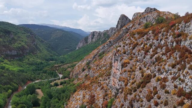 Aerial view of premature foliage yellowing and colorful dry mountain slopes due to severe heatwave near Ainsa, Pyrenees, Spain