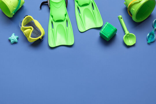 Summer vacation and beach travel planning, snorkeling gear and children sand toys on blue background with copy space for holiday advertisement design