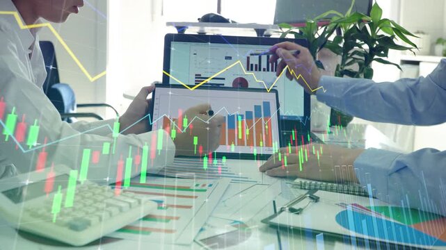 Stock traders discuss and analyze financial market data charts