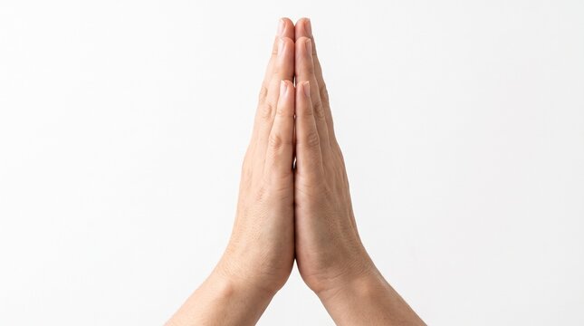 Close up of hands pressed together in a gesture of prayer or meditation.