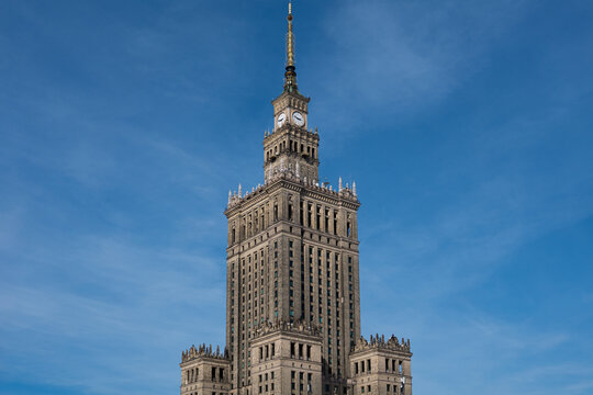 Palace of Culture and Science clock tower against clear blue sky, low angle view in Warsaw, Poland
