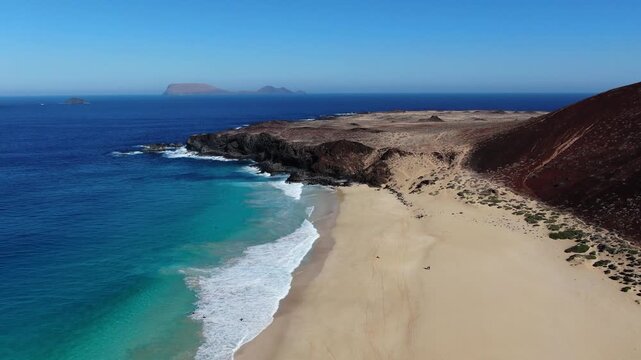 Scenic Aerial Flyaway Revealing Las Conchas Beach and Distant Monta&ntilde;a Clara