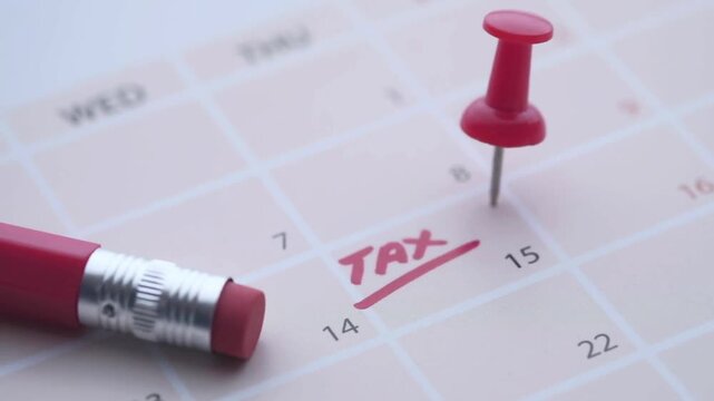 Tax day concept with tax word on calendar date.
