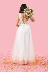 Fototapeta premium Wedding celebration and bridal joy, bride in white lace dress holding floral bouquet with gold confetti on pink background for marriage ceremony