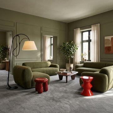 Modern green living room with red stool, minimalist lounge interior with olive green rounded sofas, a black sculptural floor lamp with cream shade, a small glossy red side table, gray carpet and muted