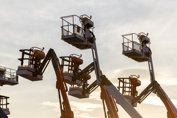 Articulate boom lift with blue sky background, Aerial platform lift telescopic boom lift hydraulic boom lift, Mobile construction crane, Construction boom lifts © Kalyakan
