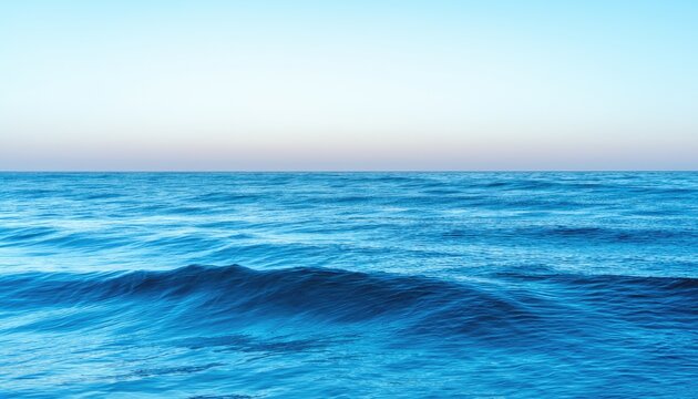 A calm ocean under a gradient sky.