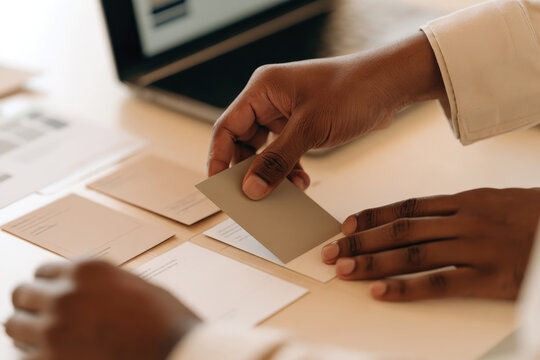 A person is carefully analyzing various cards laid out on a table, showcasing a methodical approach to sorting and evaluating important information.