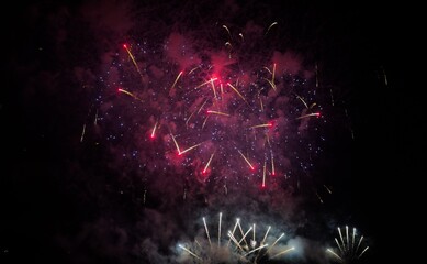 Fototapeta premium Colorful fireworks over cityscape at new year night