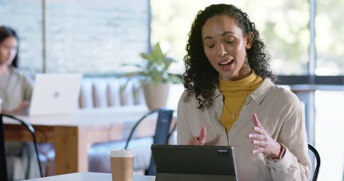Diverse female patrons at cafe Asian woman viewing tablet gesturing, explaining typing on folio