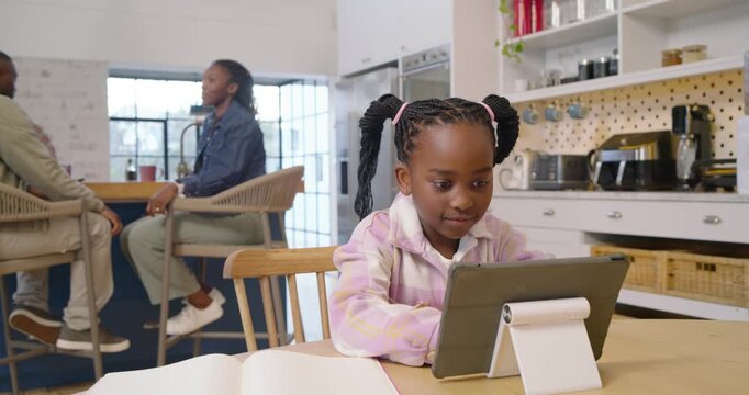 African American family girl tapping tablet at home, mother moving over guiding book, copy space