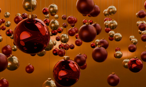 Hanging red and gold 3D Christmas baubles in warm light