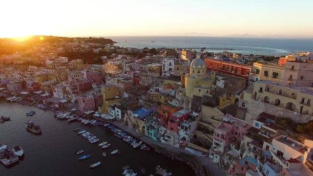 Colorful Procida waterfront and harbor in warm sunset light Italy