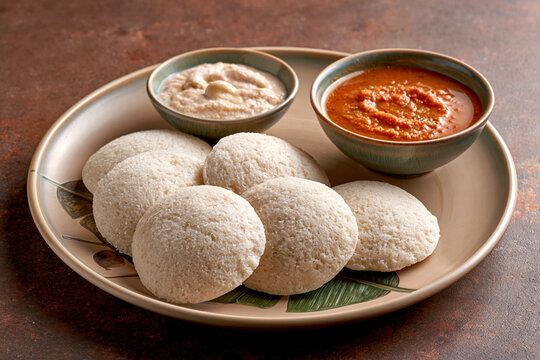 Freshly steamed idli with coconut chutney and sambar highlighting traditional South Indian fermentation and grain legume food science