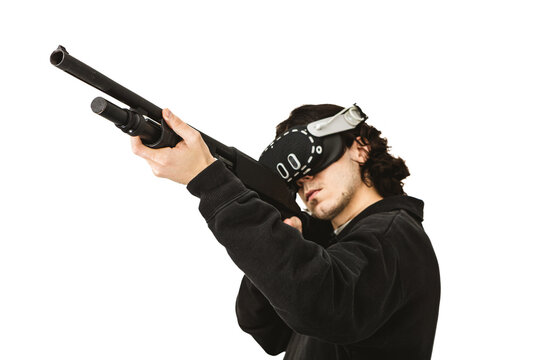 Man wearing virtual reality headset aiming shotgun controller in VR shooting simulation