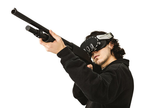 Man wearing virtual reality headset aiming shotgun controller in VR shooting simulation