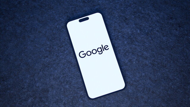 Top view of the Google logo displayed on a smartphone lying on a fabric surface, in the dark. October 8, 2026, Lisbon, Portugal.