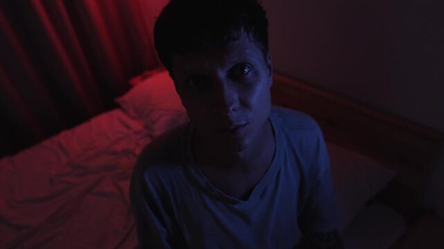 Desperate man confiding in an unseen person while looking directly into the camera, expressing guilt, emotional pain and inner conflict as if speaking to an imaginary friend in a dark bedroom