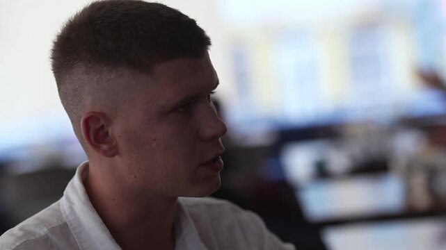 A young man is talking seriously with an interlocutor