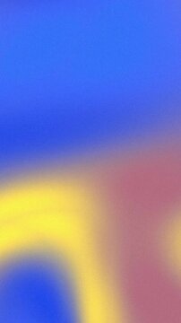 Vibrant abstract blurred gradient background with smooth transition of blue, yellow and pink tones.